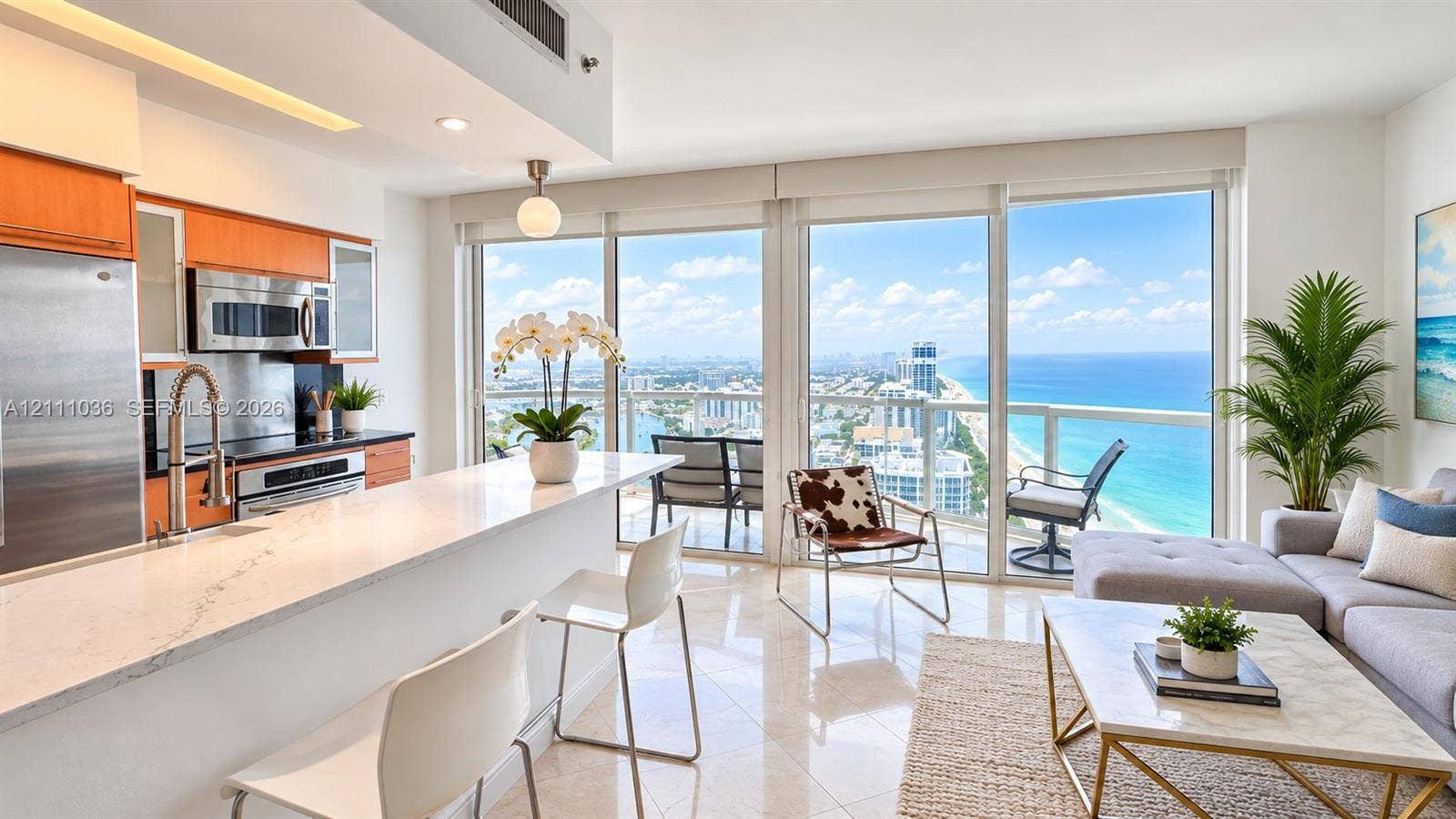 6365 Collins Avenue, #3811, Miami Beach, FL 33141 Kitchen featuring stone-surface countertops, wood-finish cabinetry, stainless steel appliances, and tile flooring, with floor-to-ceiling glass paneling and a balcony
