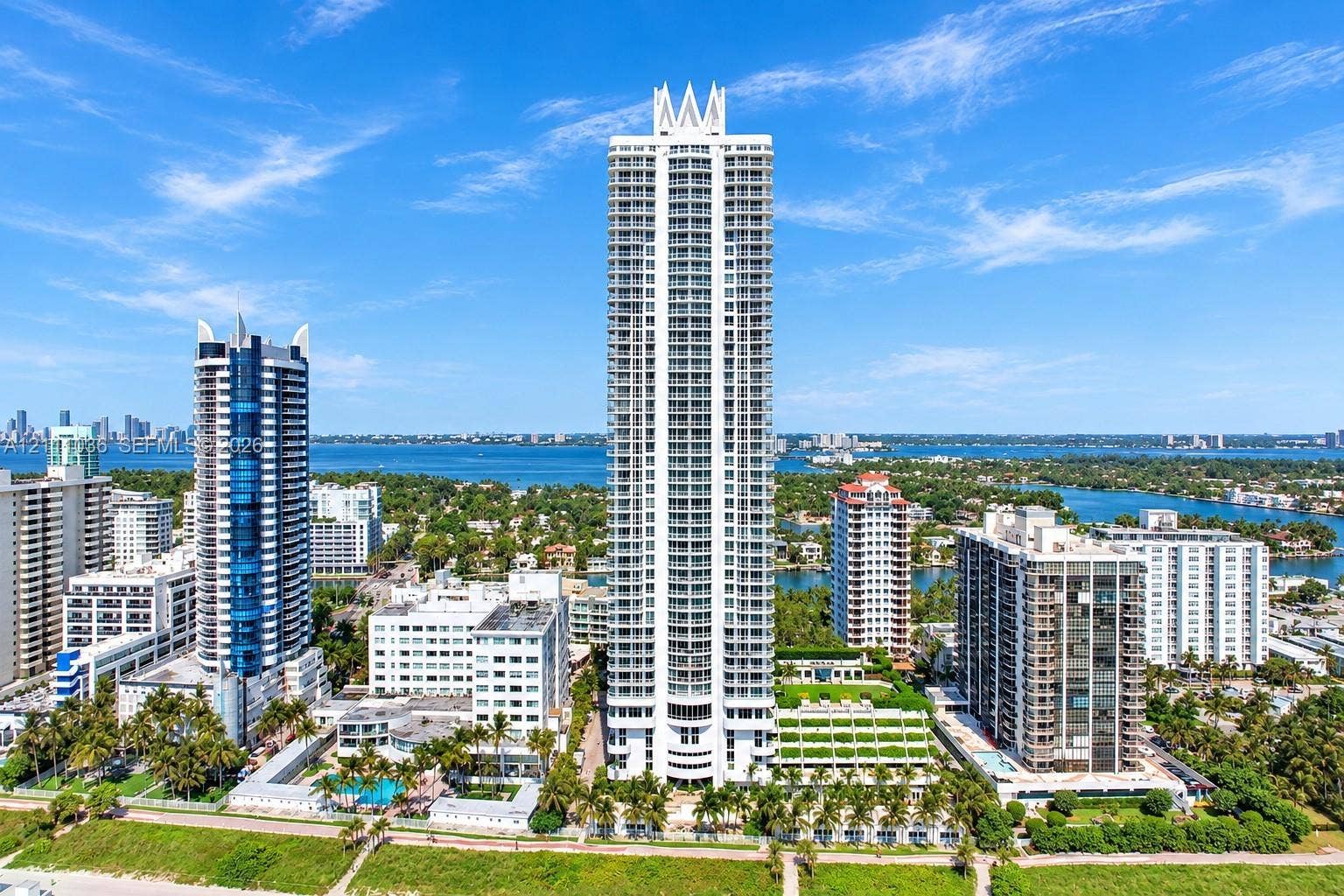 6365 Collins Avenue, #3811, Miami Beach, FL 33141 High-rise architectural exterior featuring a prominent crown design, multiple levels of private balconies, concrete construction, and extensive glass facade