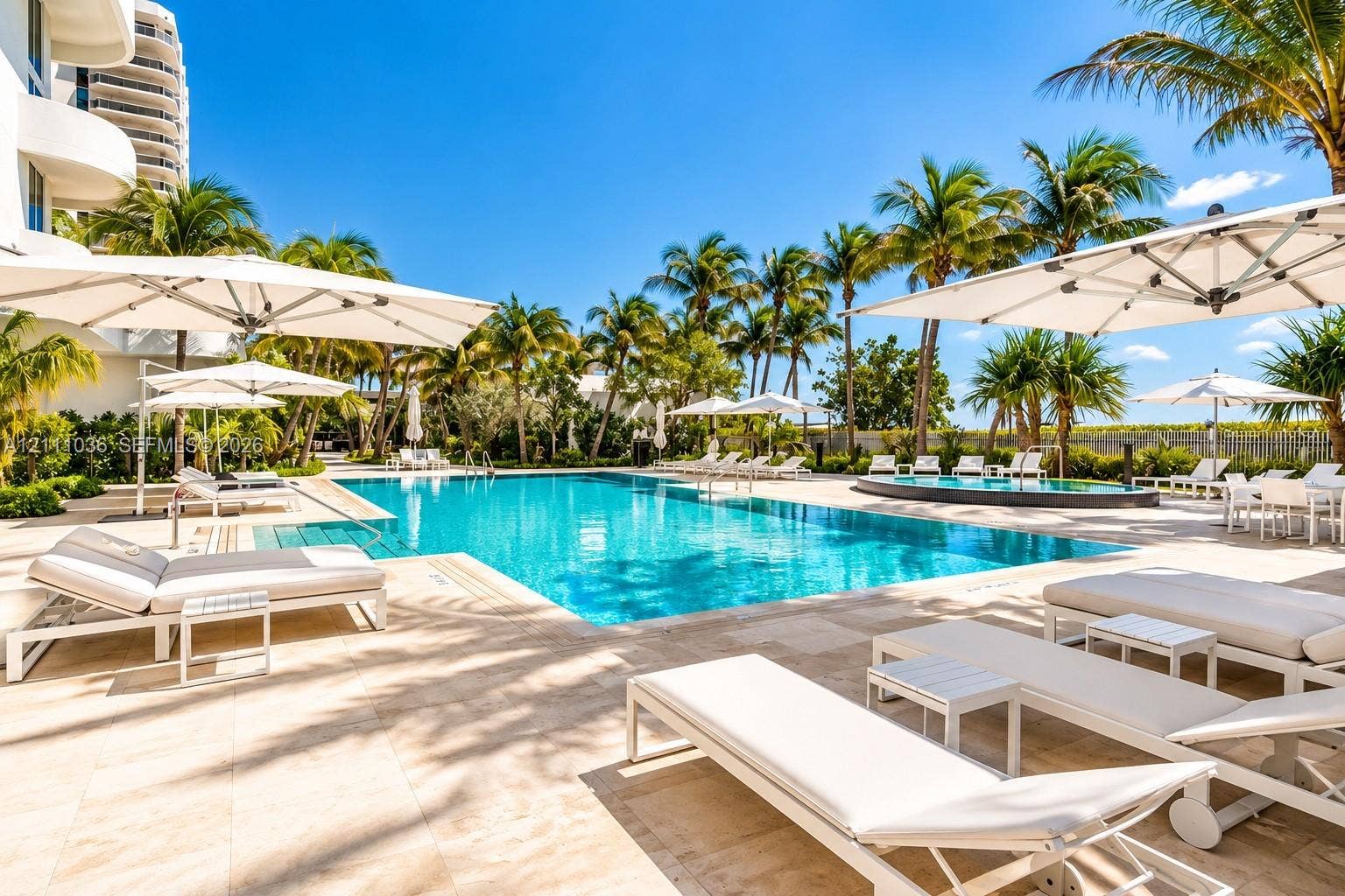 6365 Collins Avenue, #3811, Miami Beach, FL 33141 Rectangular swimming pool with stone-tiled decking, integrated spa, and mature palm trees
