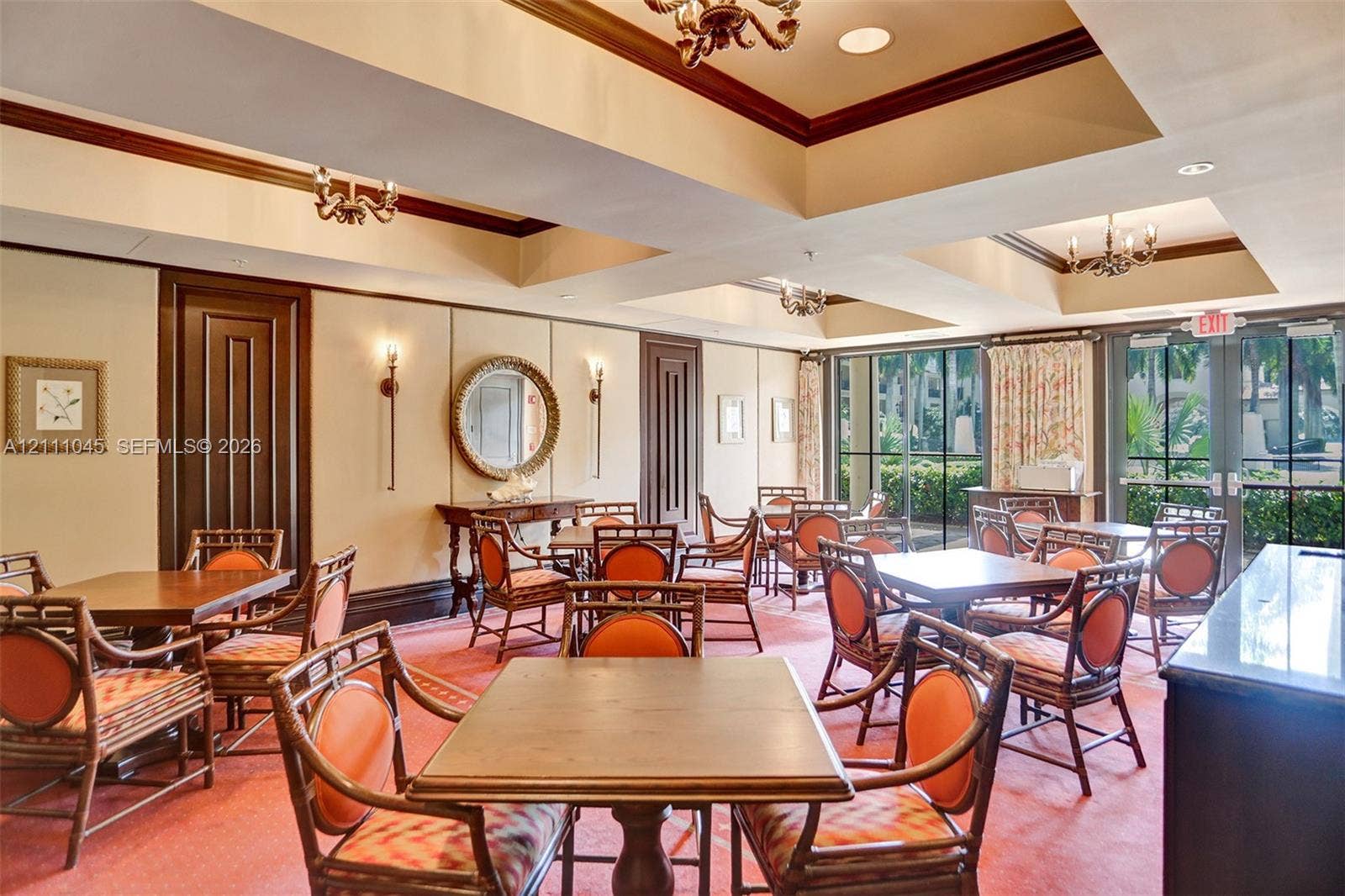 2901 NW 126th Avenue, #2-225, Sunrise, FL 33323 Tray ceiling with recessed lighting, panel-style wall detailing, floor-to-ceiling windows, and multiple built-in chandeliers