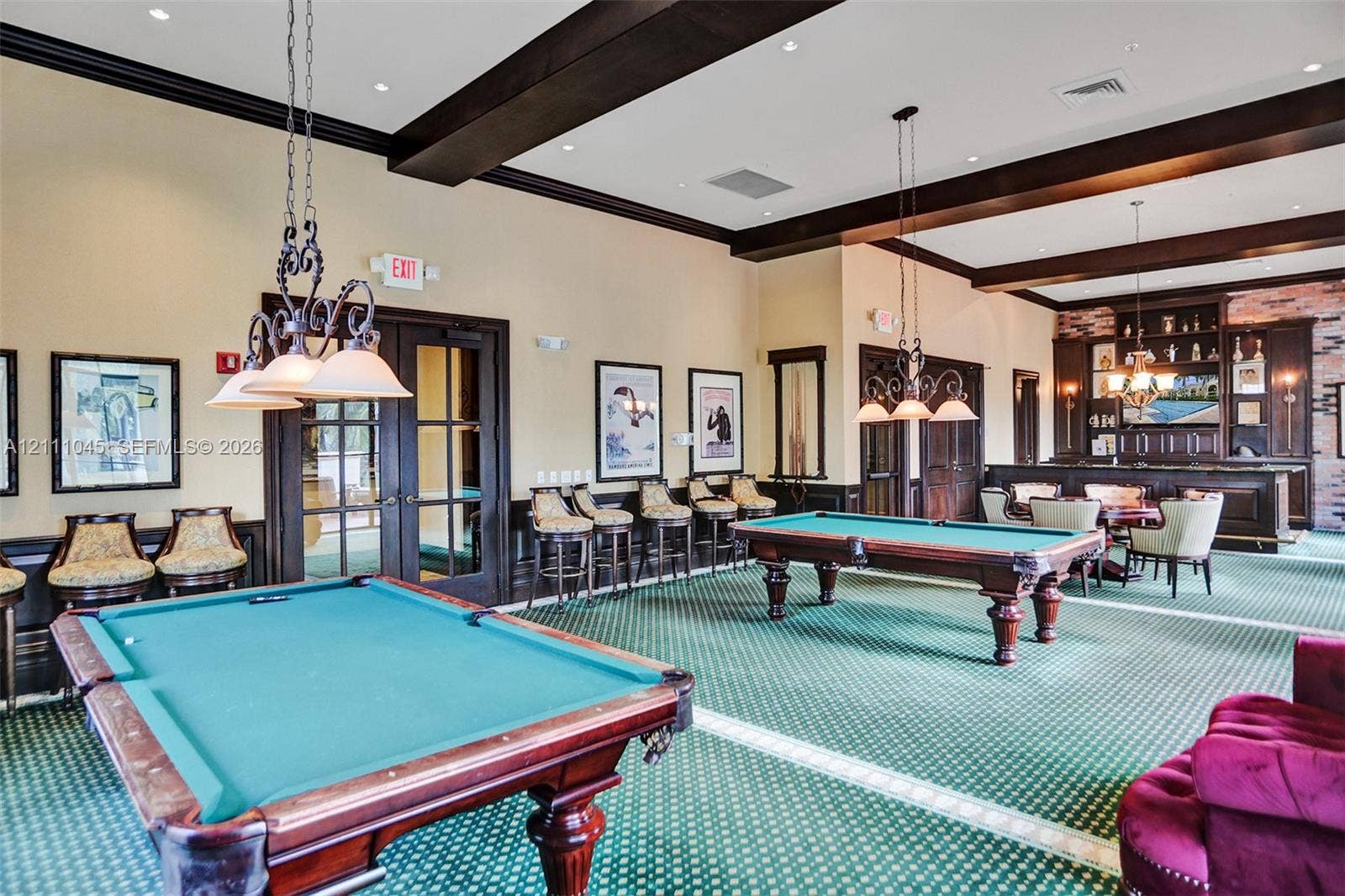 2901 NW 126th Avenue, #2-225, Sunrise, FL 33323 Large recreation room featuring dark wood ceiling beams, decorative crown molding, a built-in wet bar with cabinetry, and recessed lighting