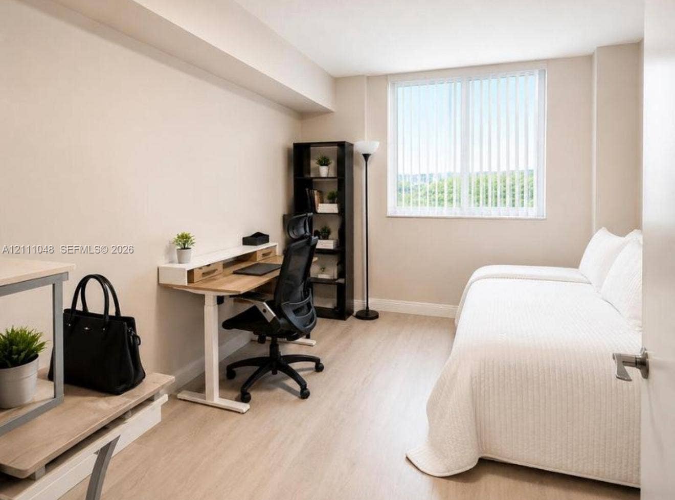 2775 NE 187th Street, #408, Aventura, Aventura, FL 33180 Neutral-toned room featuring wood-finish flooring, a large window with vertical blinds, and a smooth wall finish
