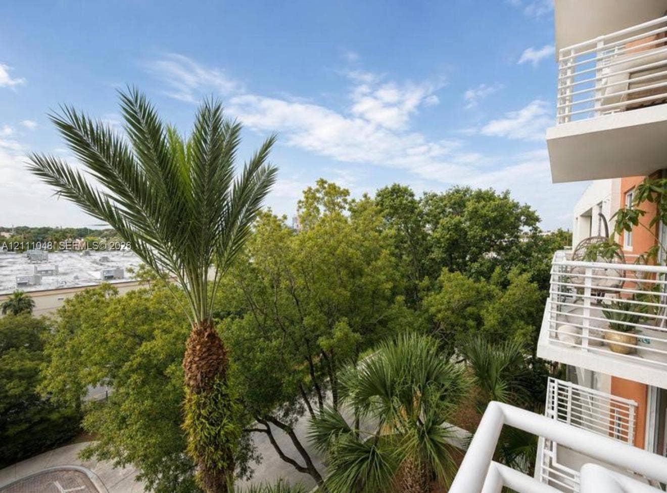 2775 NE 187th Street, #408, Aventura, Aventura, FL 33180 Elevated balconies with white metal railings and mature palm tree landscaping