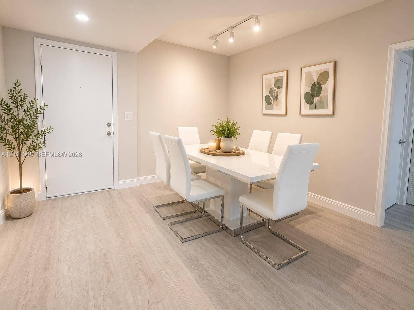 2775 NE 187th Street, #408, Aventura, Aventura, FL 33180 Neutral-toned interior featuring wood-finish flooring, recessed lighting, and adjustable multi-bulb track lighting
