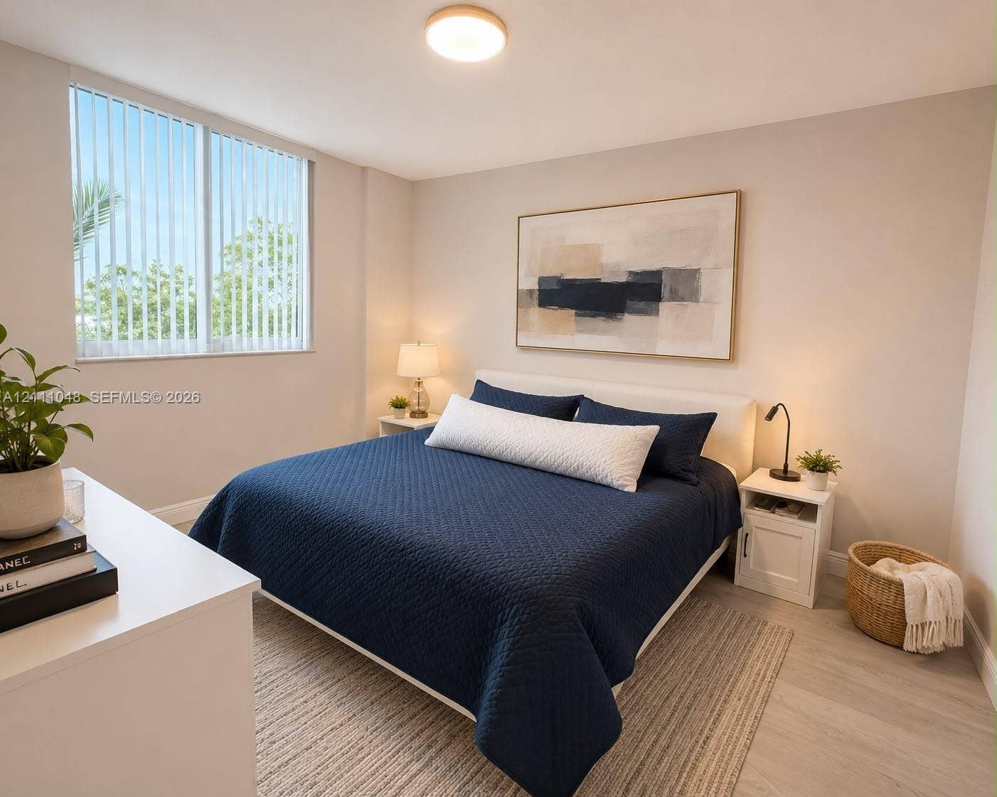 2775 NE 187th Street, #408, Aventura, Aventura, FL 33180 Neutral wall tones, wood-finish flooring, and a large window featuring vertical blinds