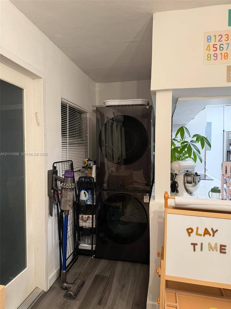 5020 Sheridan Street, #2, Hollywood, FL 33021 Open-concept interior featuring wood-finish flooring, a pass-through window with a serving ledge, an exterior door with a glass inlay, and contemporary multi-bulb ceiling lighting