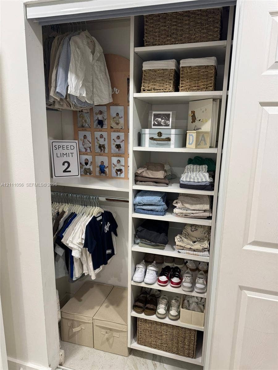 5020 Sheridan Street, #2, Hollywood, FL 33021 Built-in closet featuring dual hanging rods and an integrated shelving tower with fixed cabinetry