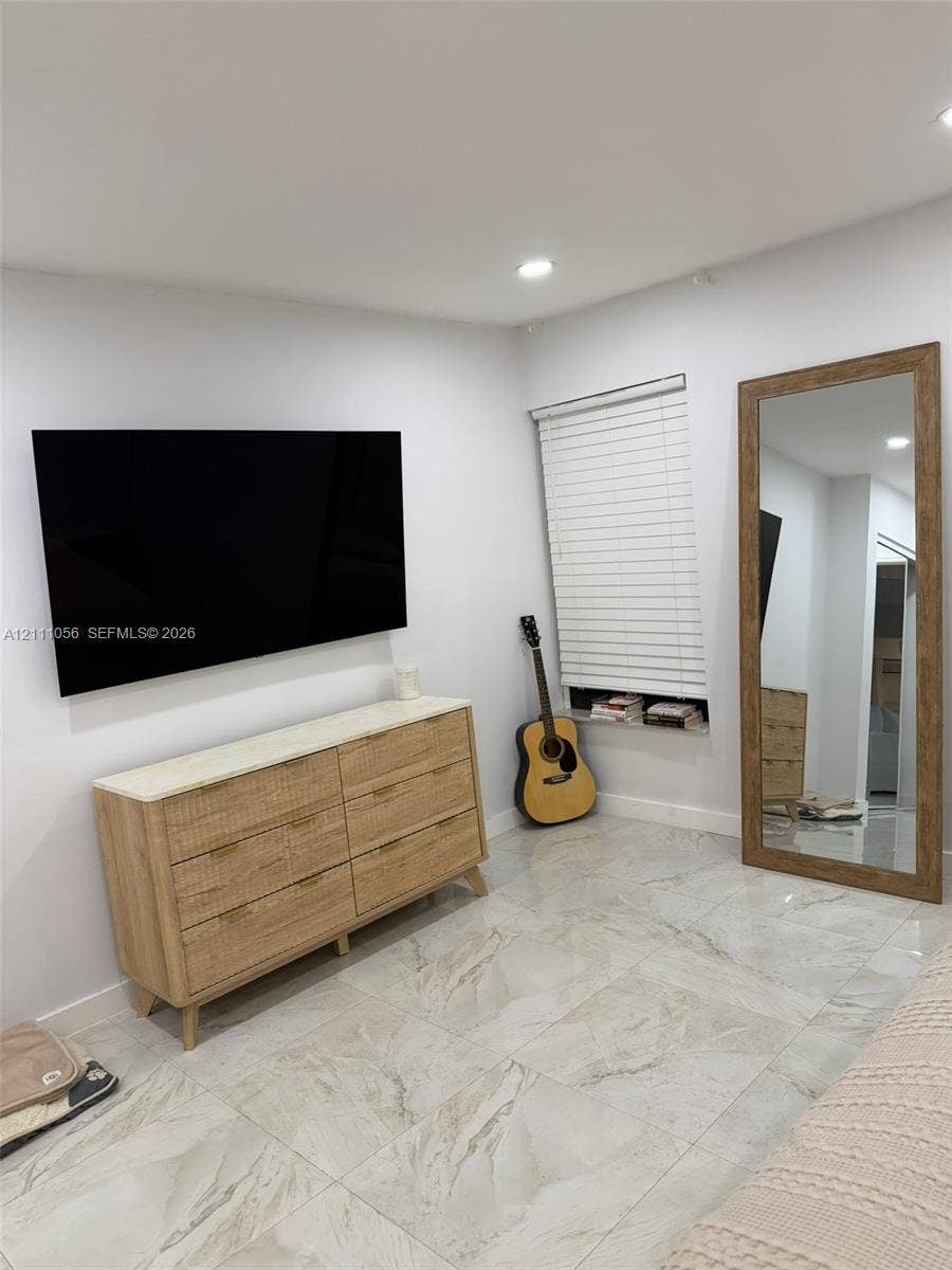 5020 Sheridan Street, #2, Hollywood, FL 33021 Large-format tile flooring, recessed ceiling lighting, and a horizontal window with slatted blinds