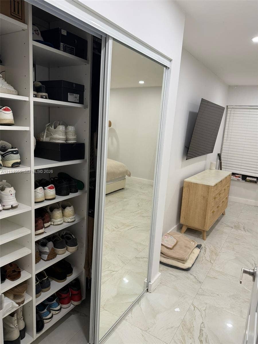 5020 Sheridan Street, #2, Hollywood, FL 33021 Built-in floor-to-ceiling shelving, sliding mirrored closet doors, and tile flooring