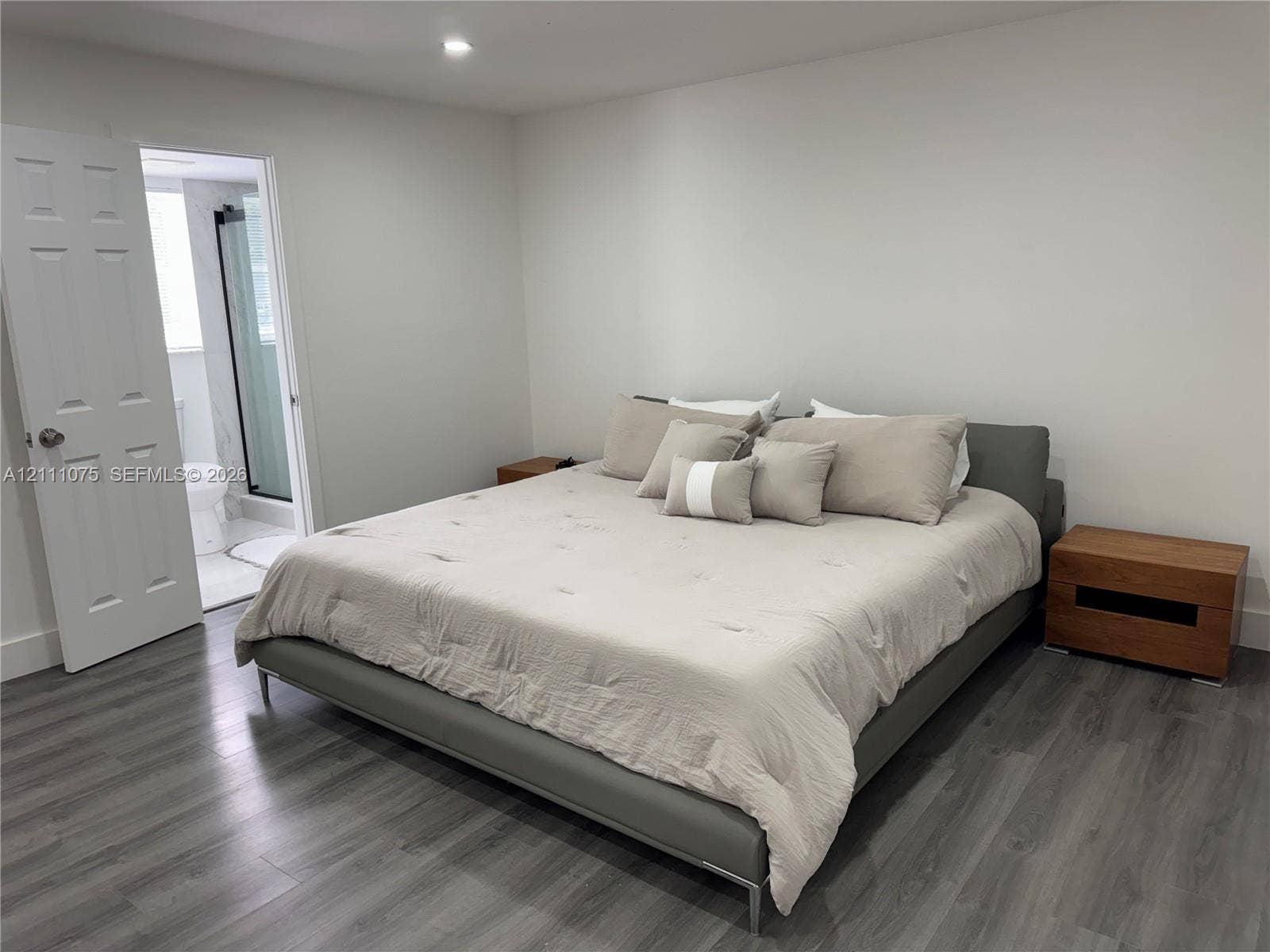2318 NE 7th Street, #34, Hallandale Beach, Hallandale Beach, FL 33009 Neutral-toned bedroom featuring wood-finish flooring, recessed lighting, and a six-panel interior door