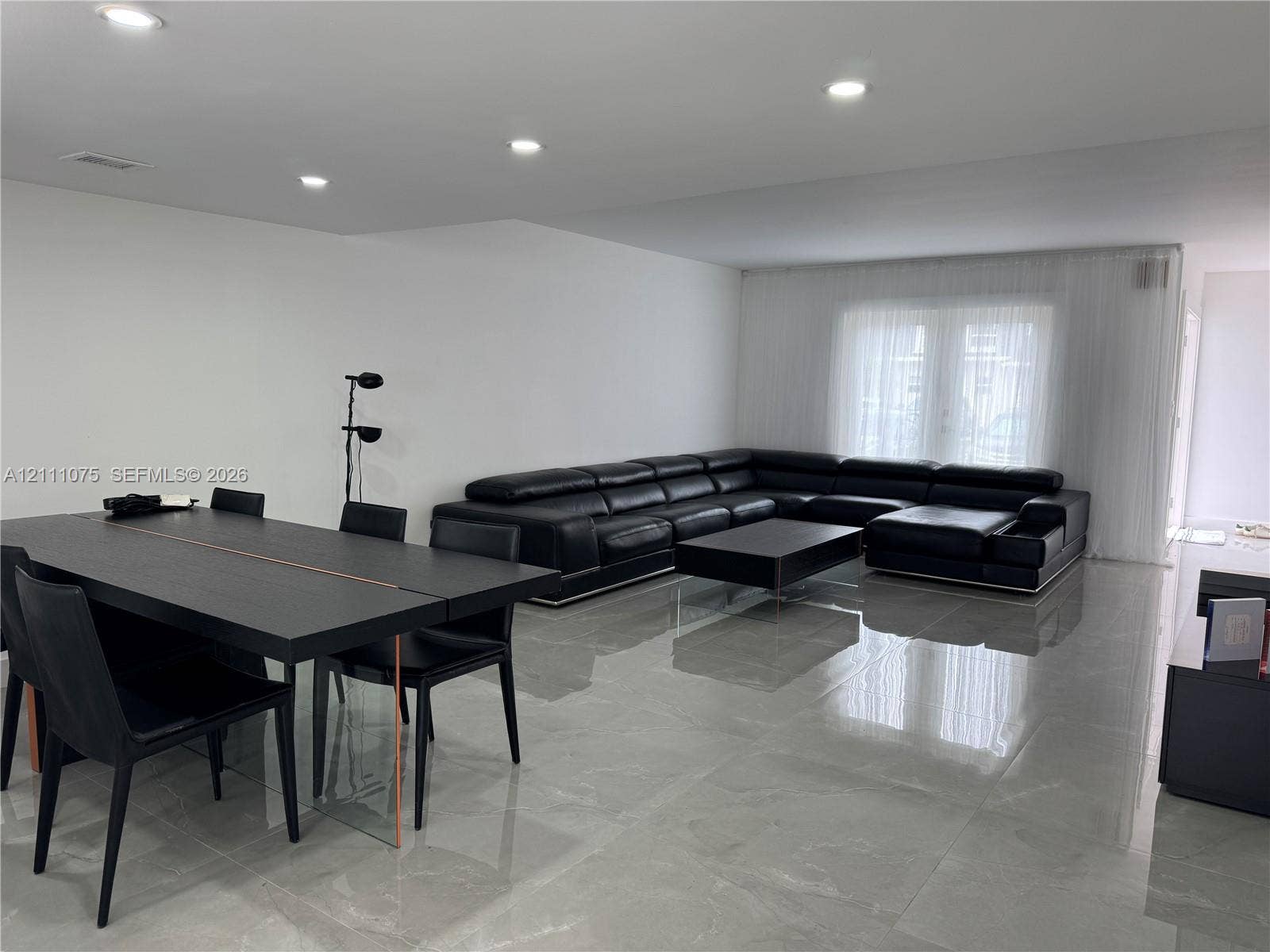 2318 NE 7th Street, #34, Hallandale Beach, Hallandale Beach, FL 33009 Polished large-format floor tile, recessed ceiling lighting, and floor-to-ceiling sheer window treatments