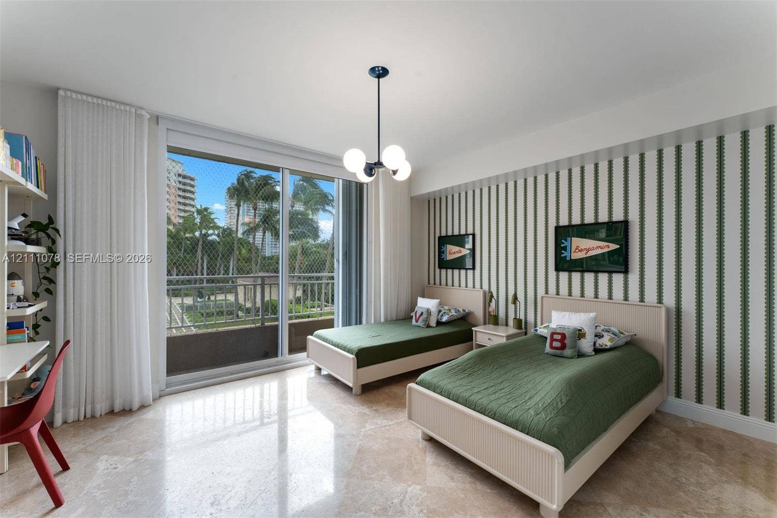765 Crandon Boulevard, #311, Key Biscayne, FL 33149 Polished stone flooring, floor-to-ceiling sliding glass doors, private balcony, built-in shelving, and designer chandelier