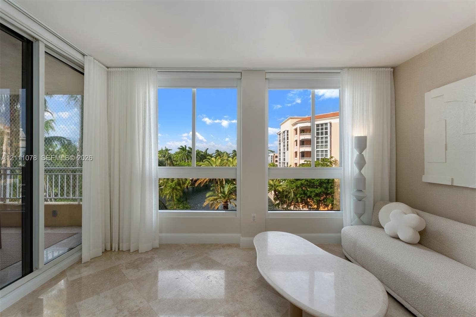 765 Crandon Boulevard, #311, Key Biscayne, FL 33149 Expansive floor-to-ceiling windows featuring stone flooring and access to a screened balcony