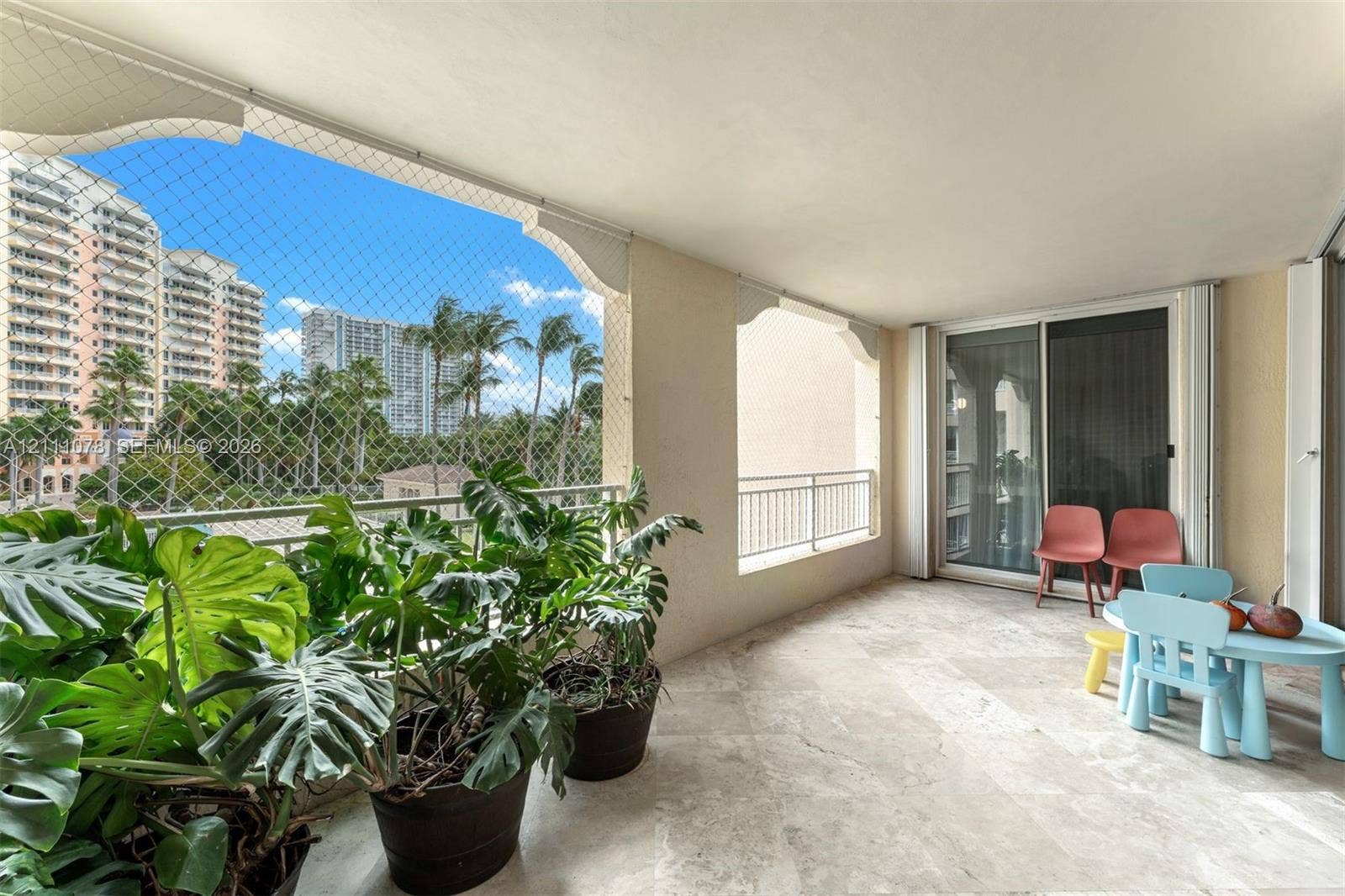 765 Crandon Boulevard, #311, Key Biscayne, FL 33149 Covered balcony featuring stone flooring, integrated archway architectural detailing, and metal railings