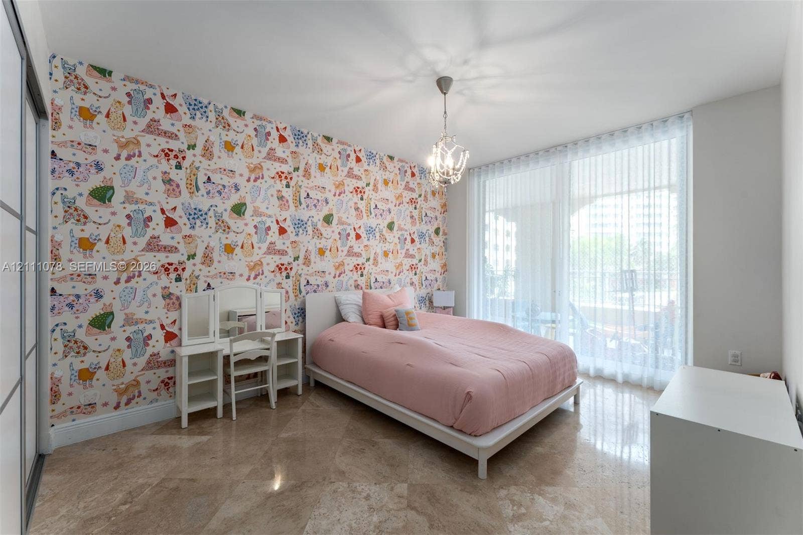 765 Crandon Boulevard, #311, Key Biscayne, FL 33149 Polished stone flooring, floor-to-ceiling glass wall with sheer drapery, decorative accent wall, and multi-arm chandelier