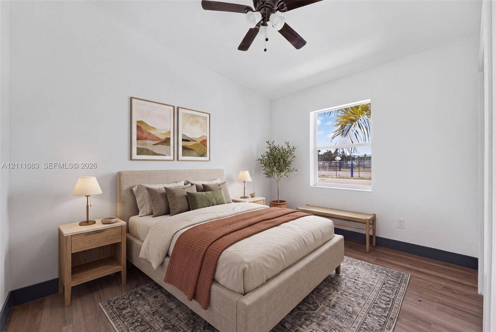 Wood-finish flooring, high ceilings, ceiling fan with integrated lighting, and a single-pane window