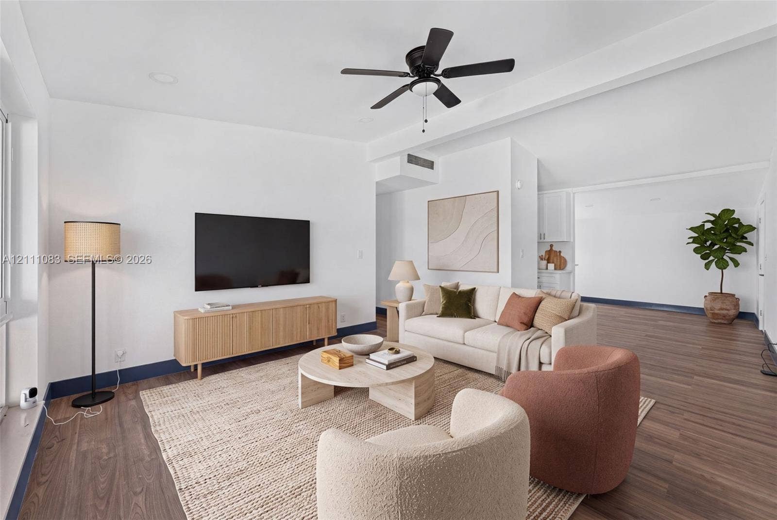 Living area featuring wood-finish flooring, recessed lighting, vaulted ceilings, and a dark-finish ceiling fan