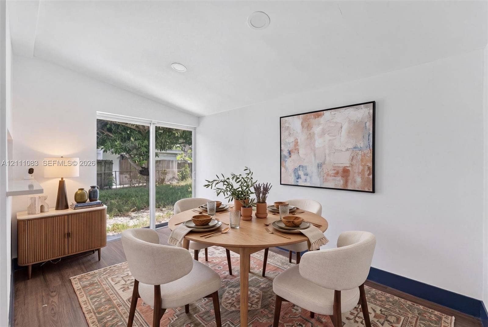 Sloped ceiling featuring recessed lighting, wood-finish flooring, and large sliding glass doors