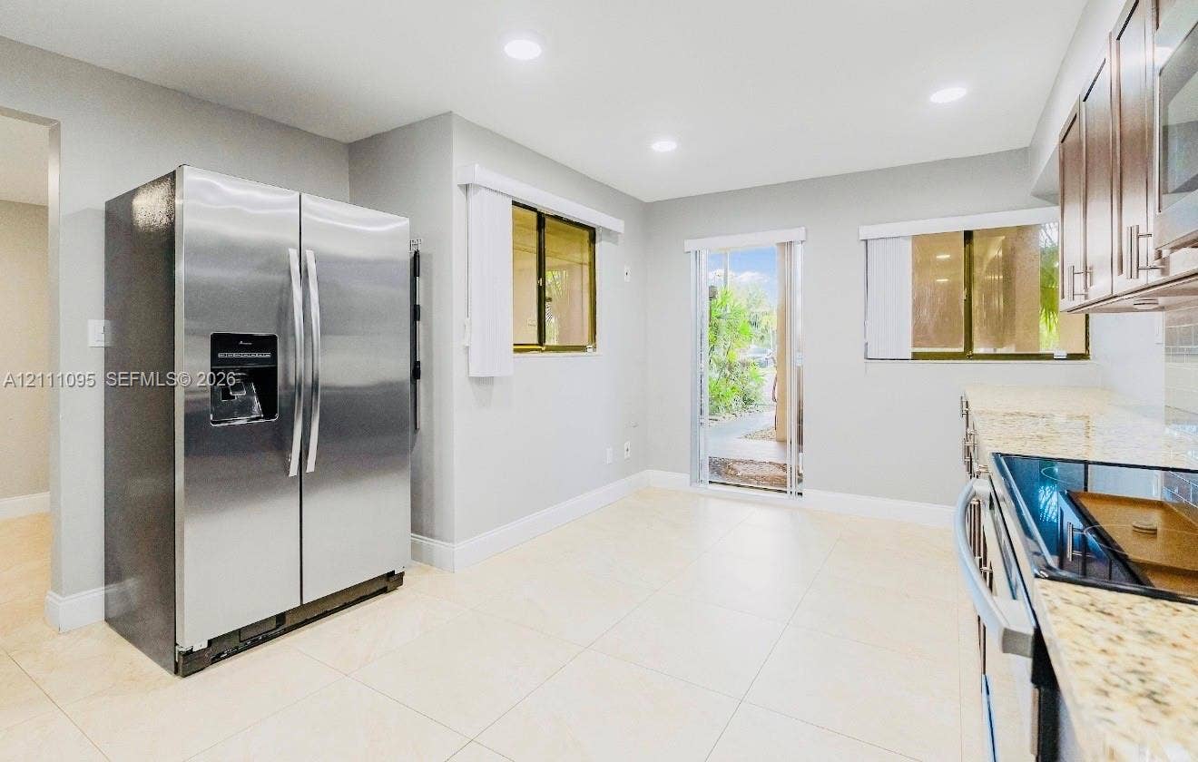 120 SW 96th Terrace, #104, Plantation, FL 33324 Kitchen featuring stone-finish countertops, stainless steel side-by-side refrigerator, tile flooring, and recessed lighting