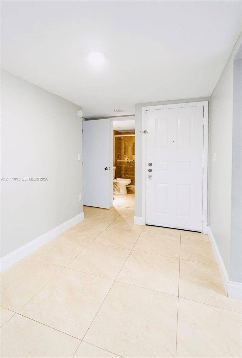 120 SW 96th Terrace, #104, Plantation, FL 33324 Neutral-toned interior featuring large-format light tile flooring, white panel doors, and recessed ceiling lighting