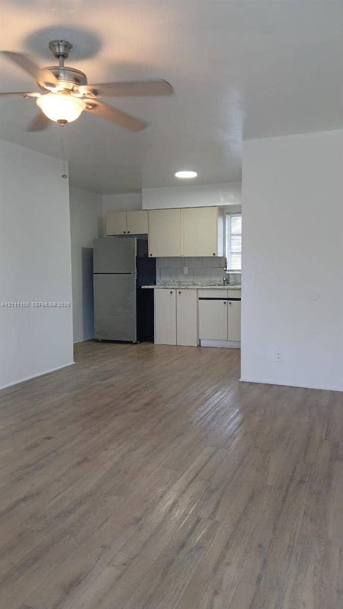 325 NE 2nd Street, #4, Hallandale Beach, Hallandale Beach, FL 33009 Wood-finish flooring, ceiling fan with integrated lighting, stainless steel refrigerator, solid-surface countertops, and cabinetry with minimalist hardware
