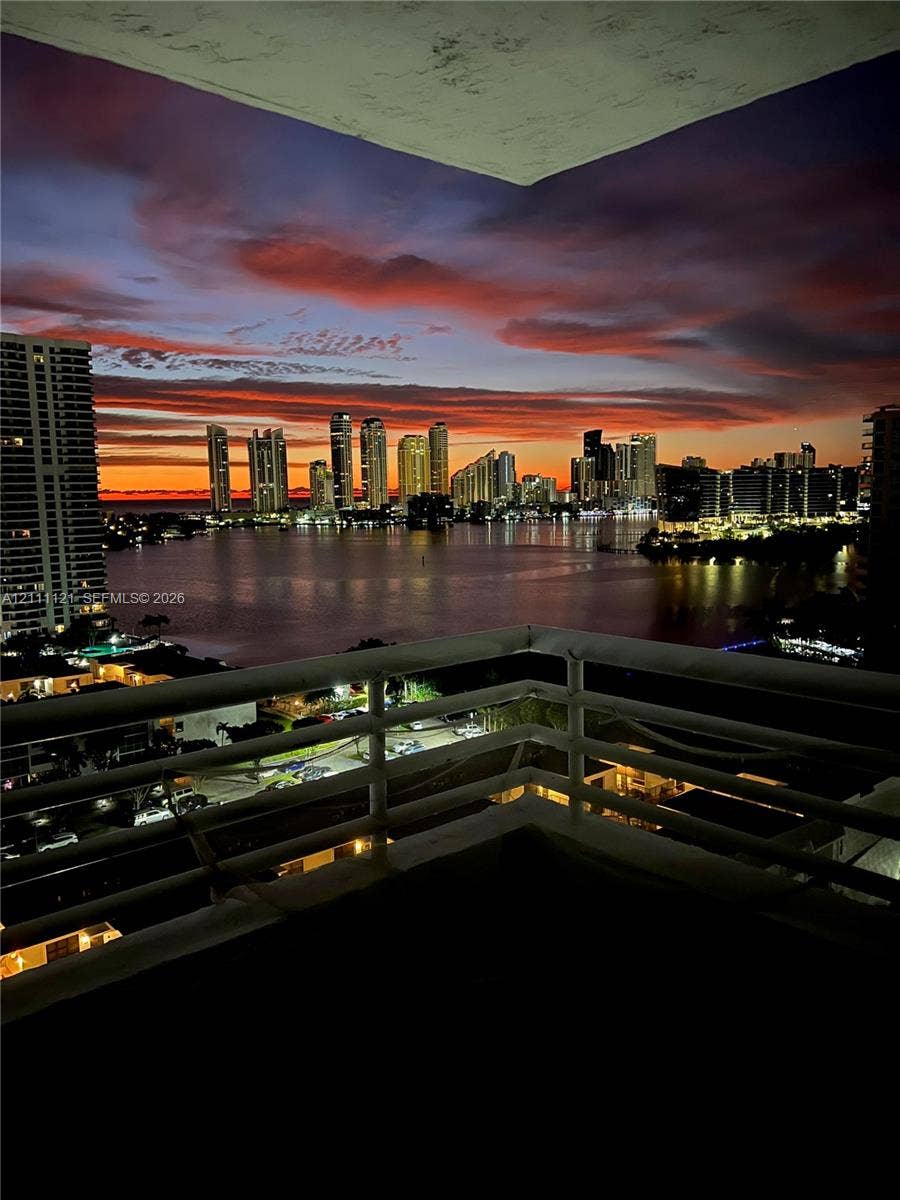 3300 NE 192nd Street, #1813, Aventura, FL 33180 Private balcony featuring a metal railing and a backdrop of waterfront skyline scenery