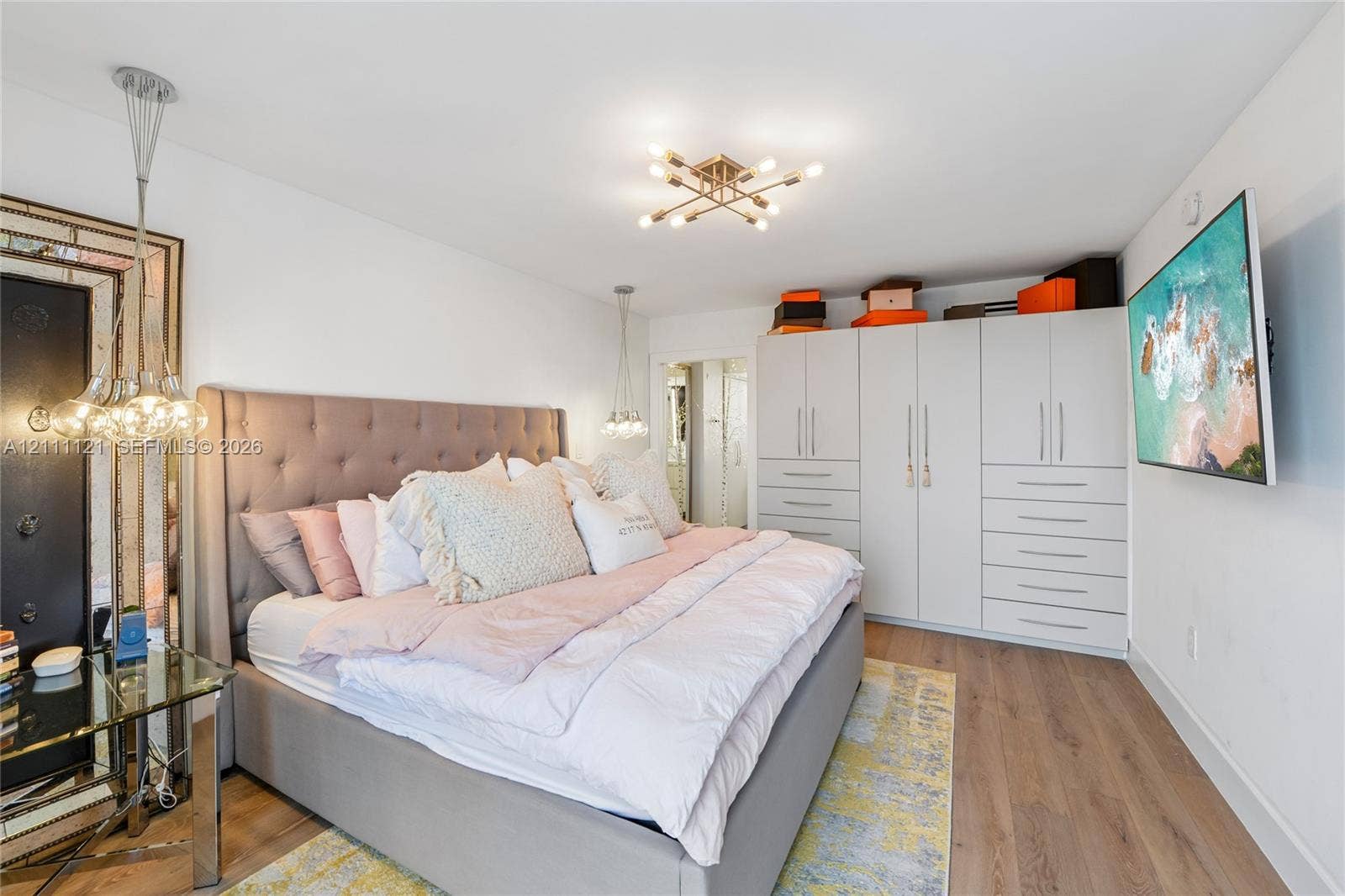 3300 NE 192nd Street, #1813, Aventura, FL 33180 Wood-finish flooring, built-in floor-to-ceiling cabinetry, multi-bulb central ceiling lighting, and pendant fixtures