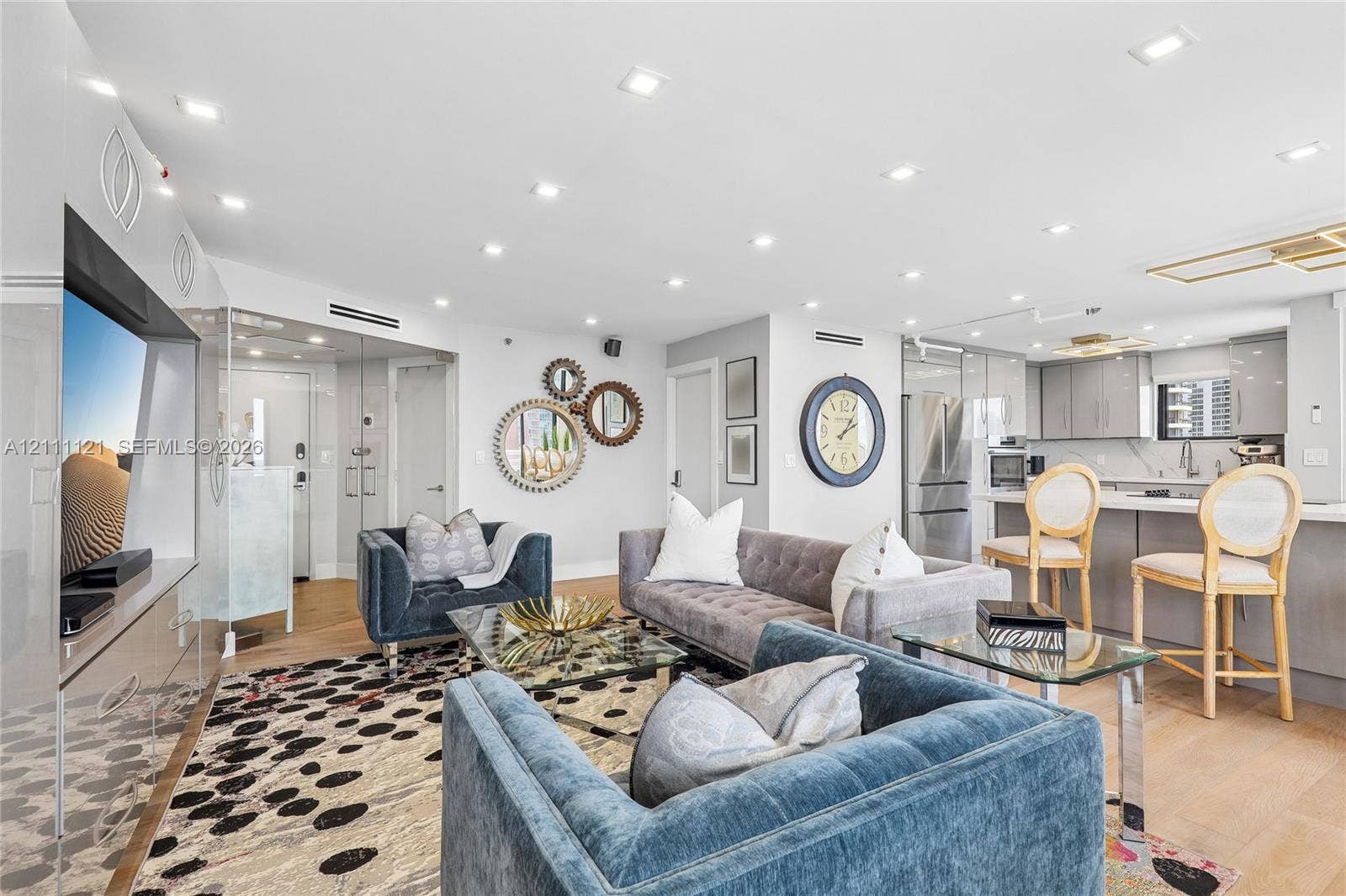 3300 NE 192nd Street, #1813, Aventura, FL 33180 Open-concept interior featuring light wood-finish flooring, recessed lighting, integrated cabinetry, and a kitchen island with stone countertops