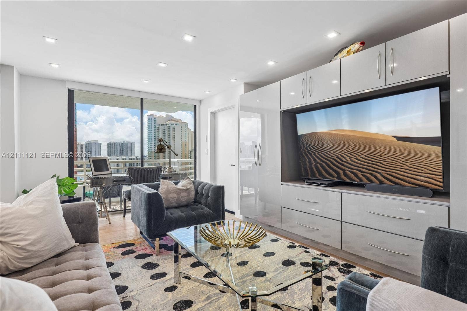 3300 NE 192nd Street, #1813, Aventura, FL 33180 Built-in high-gloss cabinetry with integrated shelving and storage, floor-to-ceiling glass sliding doors, recessed lighting, and wood-finish flooring