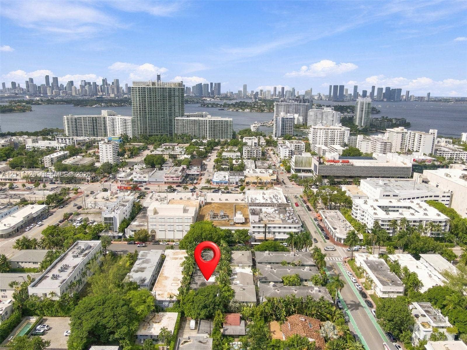 Aerial perspective of the property location featuring mature tree canopy, dense urban surroundings, and proximity to the waterfront