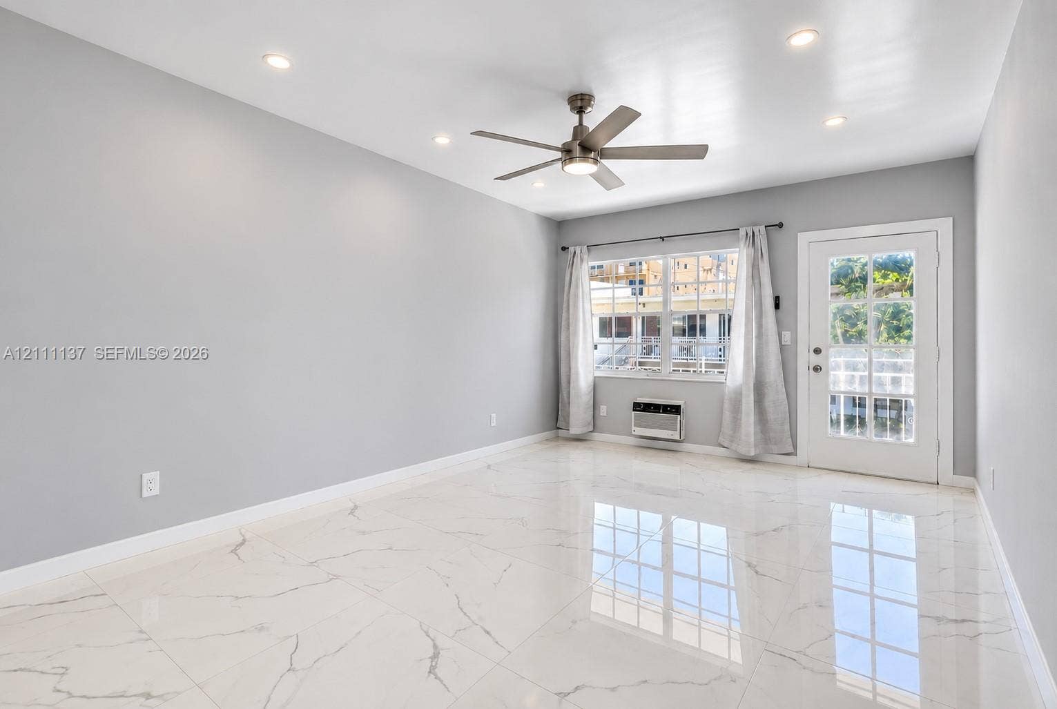 635 8th Street, #205, Miami Beach, Miami Beach, FL 33139 Interior space featuring large-format tile flooring with veining, recessed lighting, ceiling fan, and a multi-lite exterior door