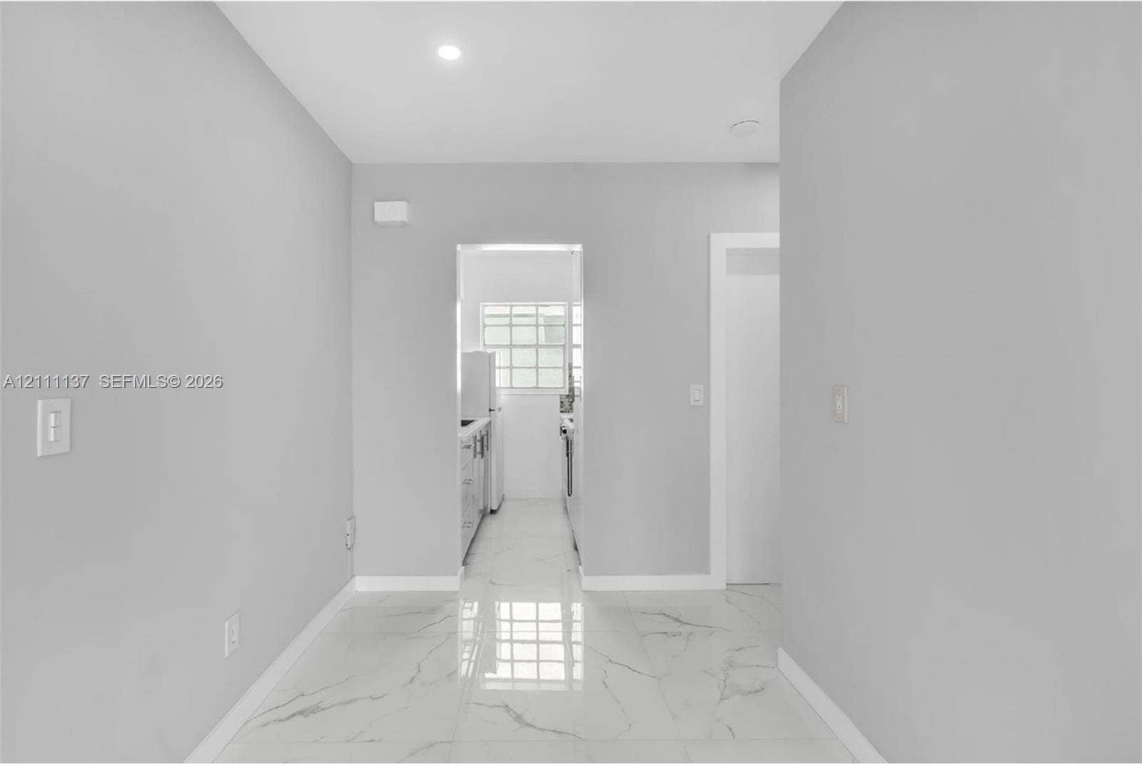 635 8th Street, #205, Miami Beach, Miami Beach, FL 33139 Large-format polished tile flooring with a marble-style vein pattern, neutral wall palette, and recessed lighting