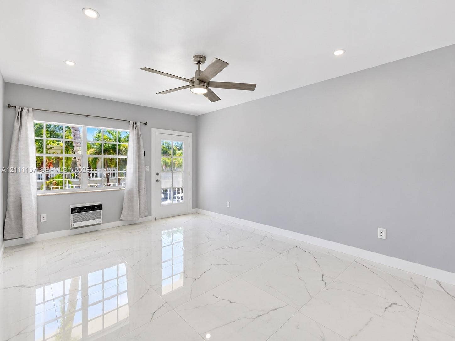 635 8th Street, #205, Miami Beach, Miami Beach, FL 33139 Large-format tile flooring with polished finish, recessed ceiling lighting, brushed metal ceiling fan with integrated lighting, multi-pane window, and exterior door with glass insert