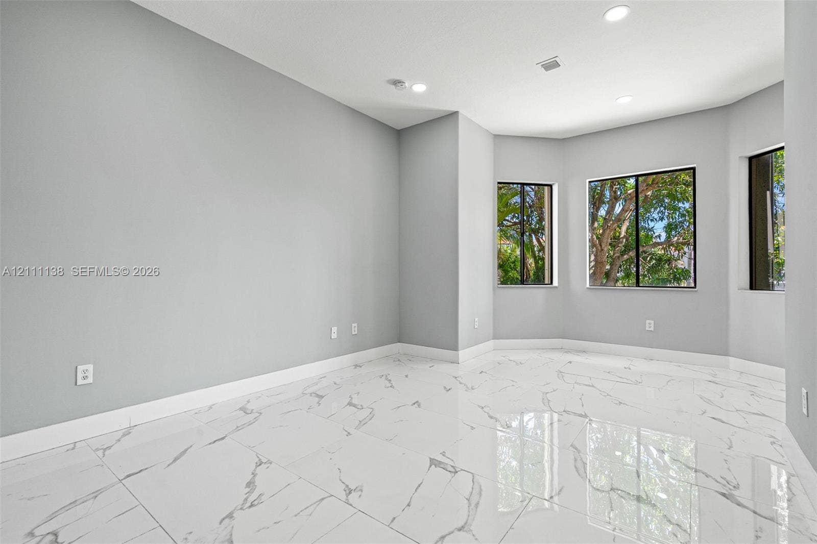 19363 SW 79th Avenue, Cutler Bay, FL 33157 Polished tile flooring with marble-patterned veining, recessed lighting, and a bay window configuration
