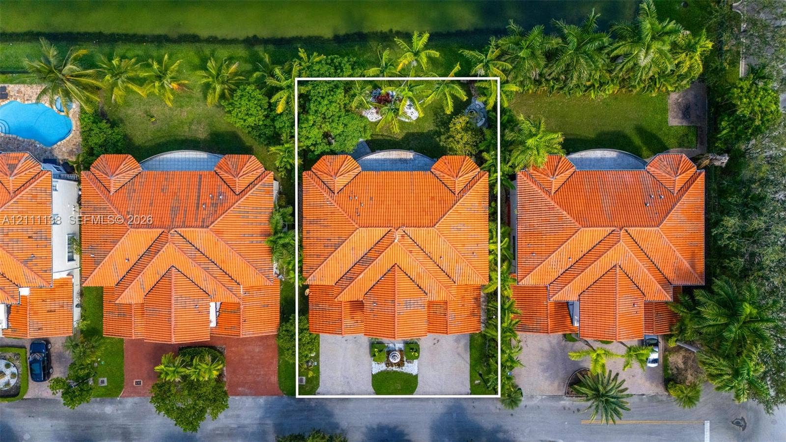 19363 SW 79th Avenue, Cutler Bay, FL 33157 Aerial perspective featuring a tile roof, paver driveway, mature landscaping, and an expansive rear lawn