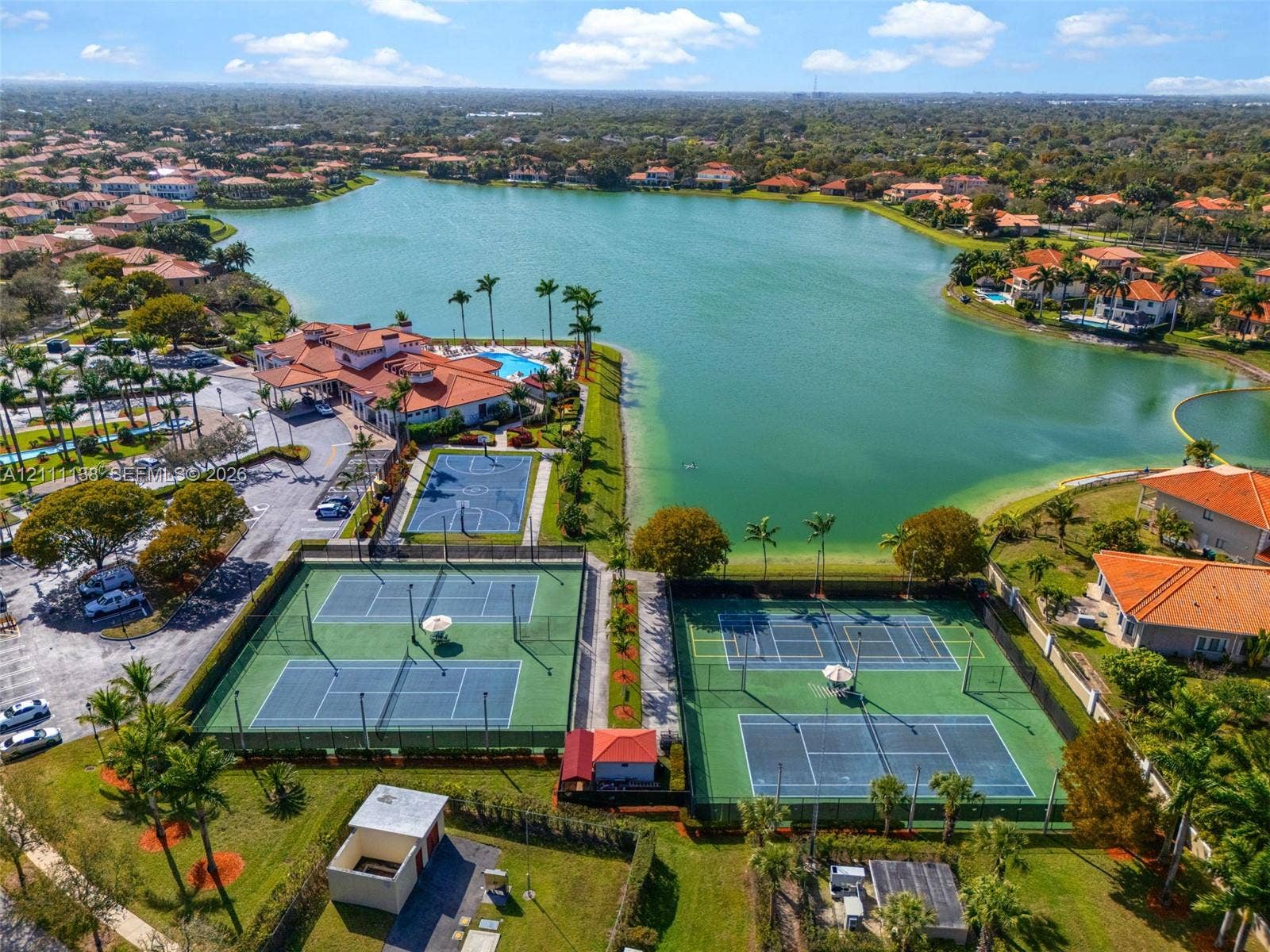 19363 SW 79th Avenue, Cutler Bay, FL 33157 Aerial view of community recreational facilities featuring multiple tennis courts, a basketball court, and immediate waterfront access