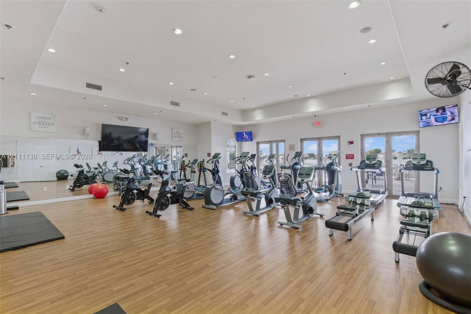 19363 SW 79th Avenue, Cutler Bay, FL 33157 Fitness center featuring wood-finish flooring, recessed lighting, wall-to-wall mirrors, and double glass-paneled doors