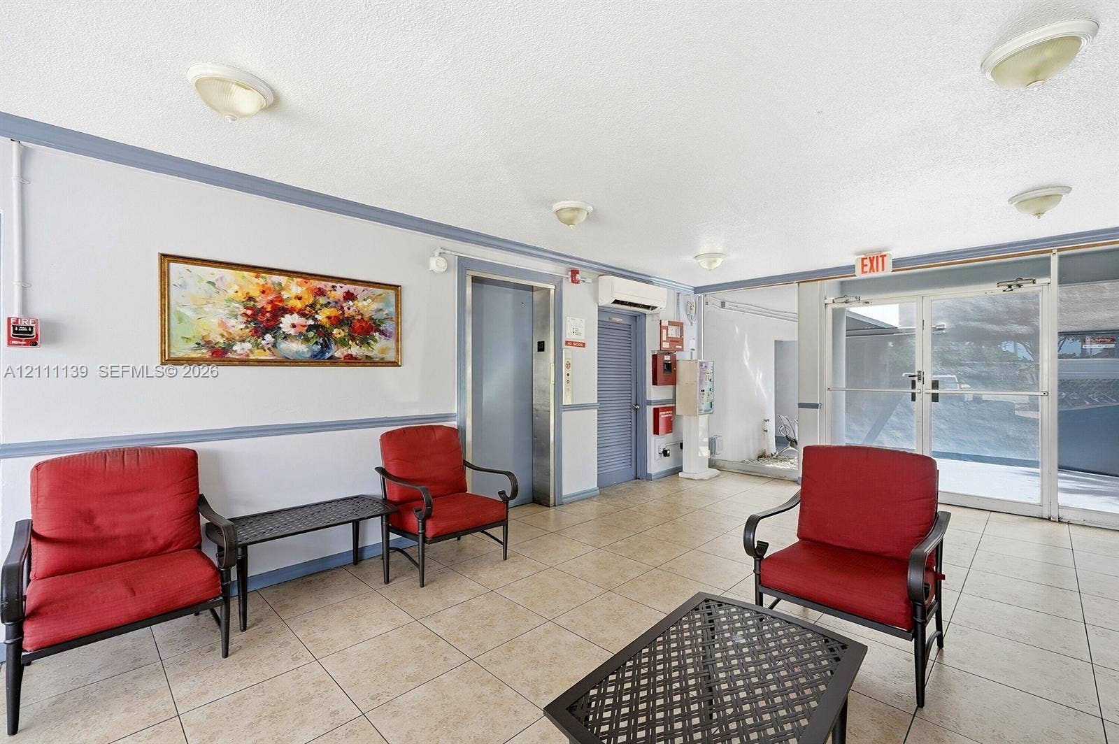 1333 E Hallandale Beach Boulevard, #236, Hallandale Beach, Hallandale Beach, FL 33009 Common area featuring neutral floor tiling, flush-mount ceiling lighting, a dedicated elevator, and a glass-paneled entry door