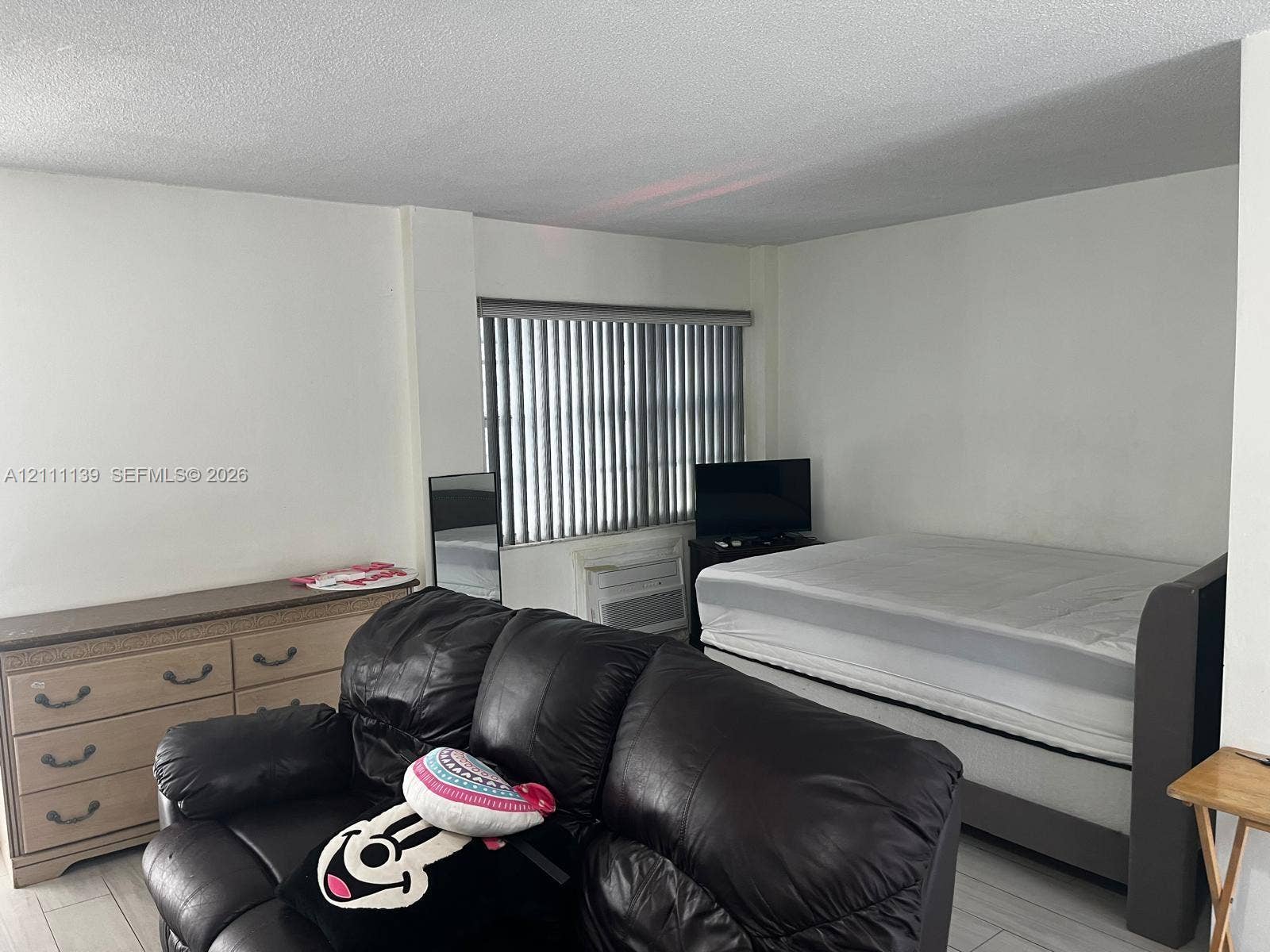1333 E Hallandale Beach Boulevard, #236, Hallandale Beach, Hallandale Beach, FL 33009 Interior space featuring neutral wall tones, light-toned flooring, and window treatments with vertical blinds