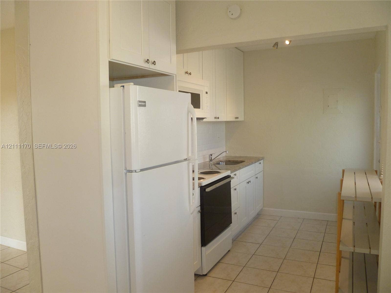 1005 N 18th Court, #5, Hollywood, Hollywood, FL 33020 Kitchen featuring white cabinetry, stone-finish countertops, tile flooring, and integrated white appliances