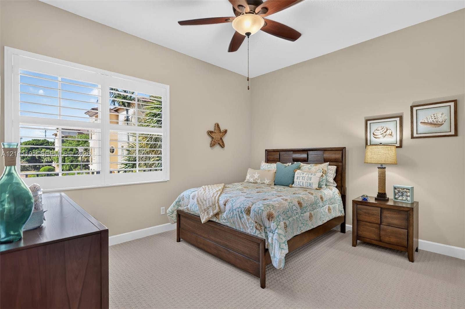 2nd floor GUEST BEDROOM. High-ceiling bedroom featuring plantation shutters, neutral carpeting, and a multi-blade ceiling fan with integrated lighting