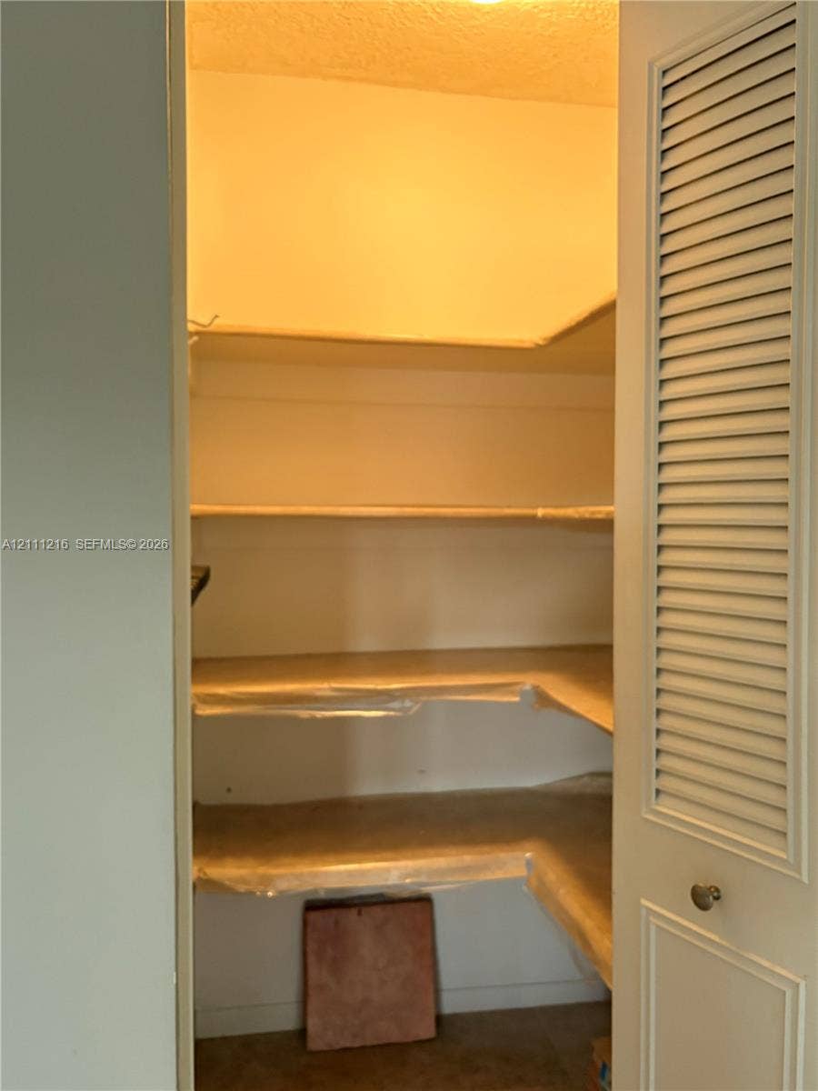 525 Coral Way, #303, Coral Gables, Coral Gables, FL 33134 Storage space featuring tiered shelving and louvered door access