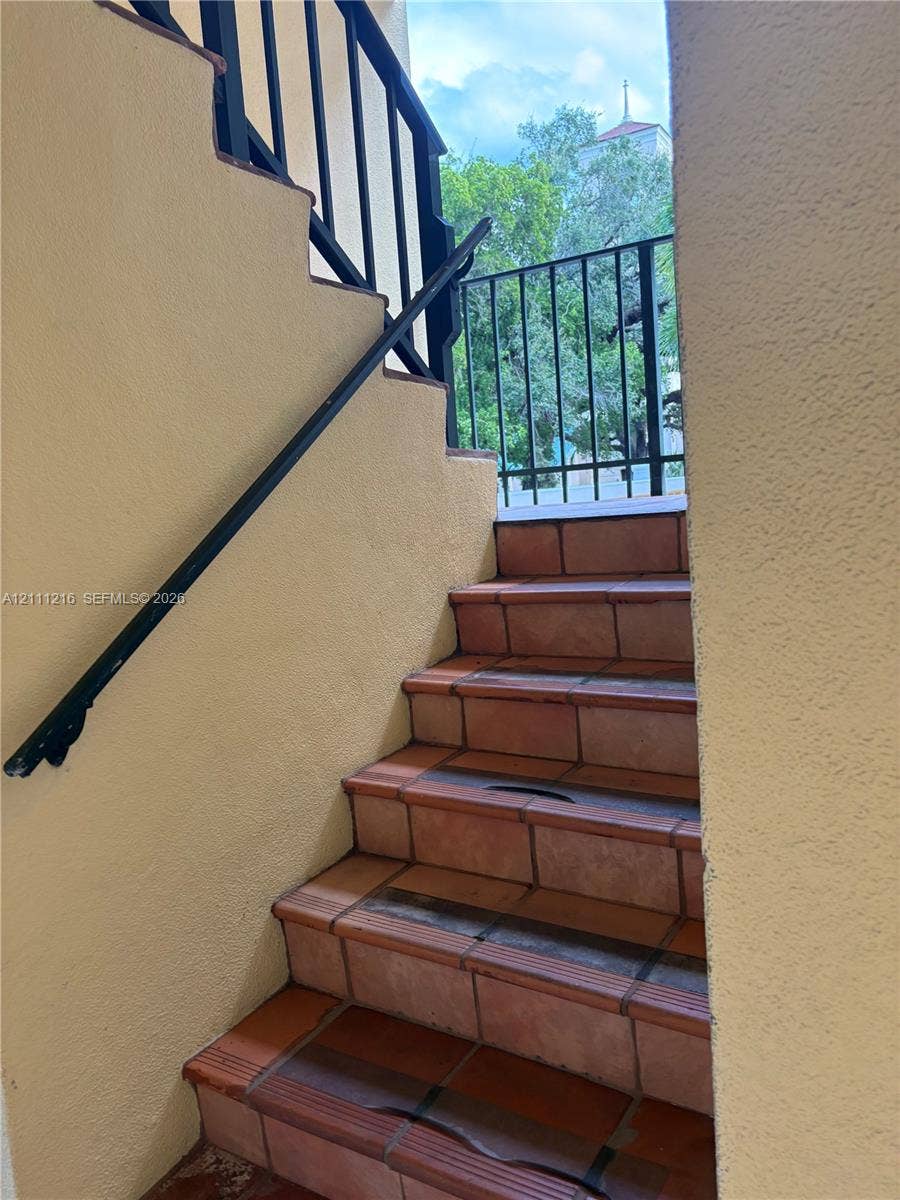 525 Coral Way, #303, Coral Gables, Coral Gables, FL 33134 Stucco staircase featuring terracotta tile treads and black metal railings