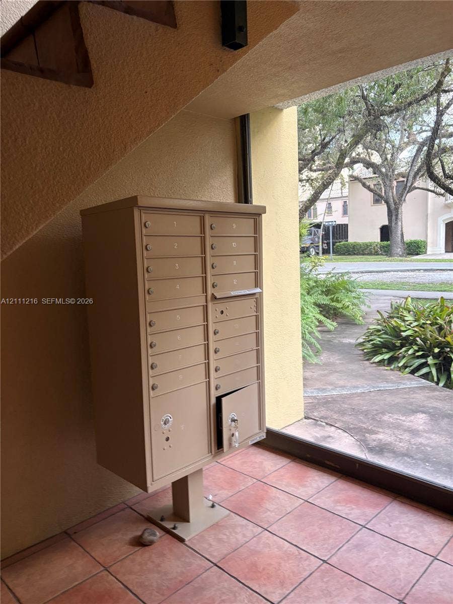 525 Coral Way, #303, Coral Gables, Coral Gables, FL 33134 Covered mail station featuring a tan metal multi-unit mailbox console situated on terracotta-style tile flooring