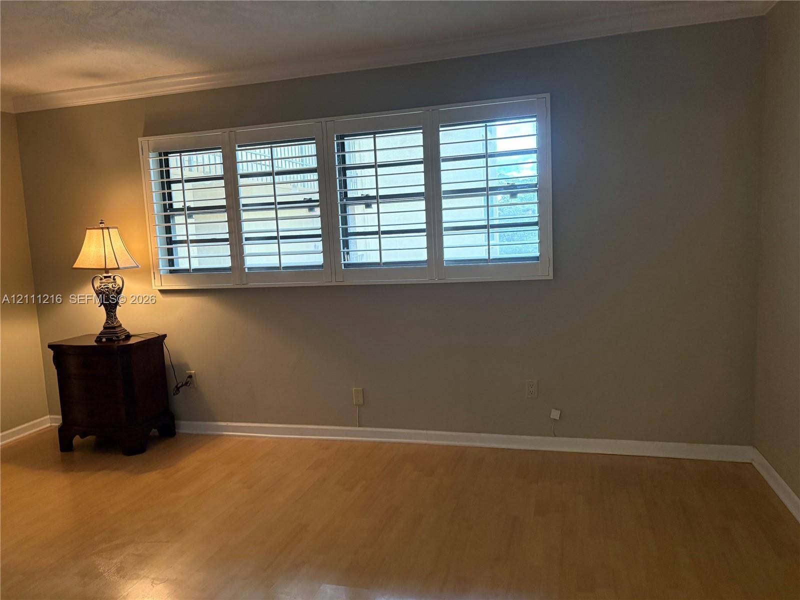 525 Coral Way, #303, Coral Gables, Coral Gables, FL 33134 Expansive four-panel window featuring white plantation shutters and wood-finish flooring