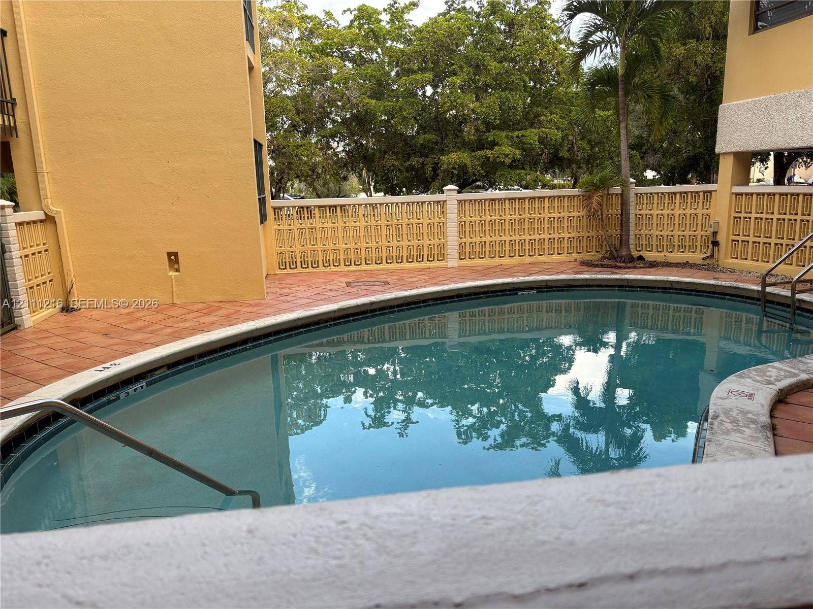 525 Coral Way, #303, Coral Gables, Coral Gables, FL 33134 In-ground swimming pool with tile surround, decorative masonry privacy wall, and metal handrails