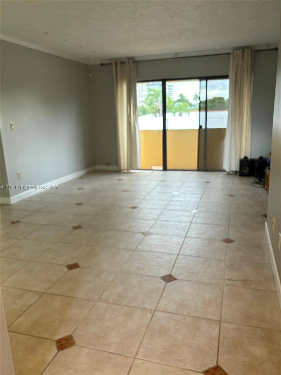 525 Coral Way, #303, Coral Gables, Coral Gables, FL 33134 Interior space featuring tile flooring with decorative stone accents and sliding glass doors providing external access