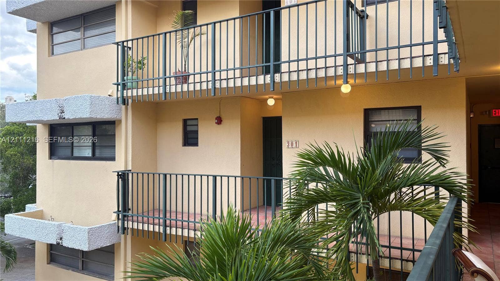 525 Coral Way, #303, Coral Gables, Coral Gables, FL 33134 Multi-level exterior featuring stucco siding, metal railings, tiled balcony flooring, and horizontal sliding windows