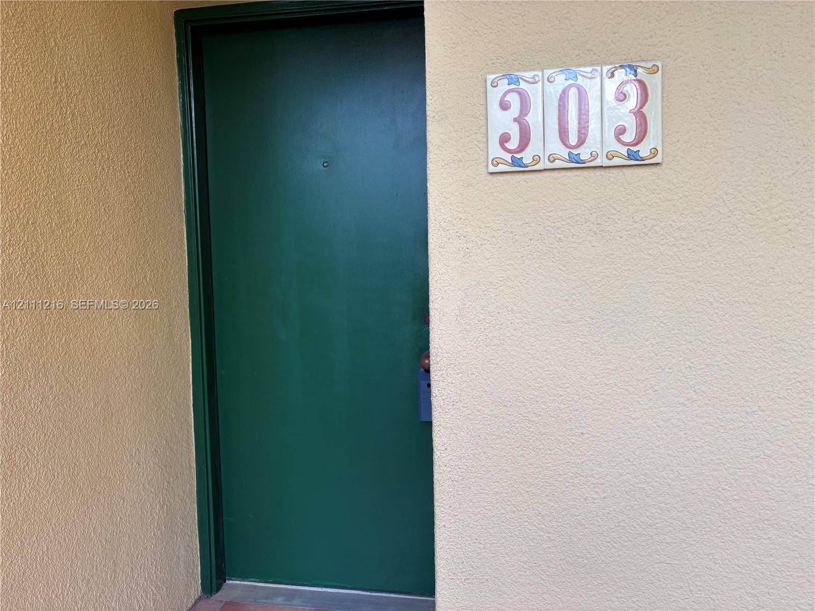 525 Coral Way, #303, Coral Gables, Coral Gables, FL 33134 Solid green entrance door with a peephole and decorative ceramic numeric signage
