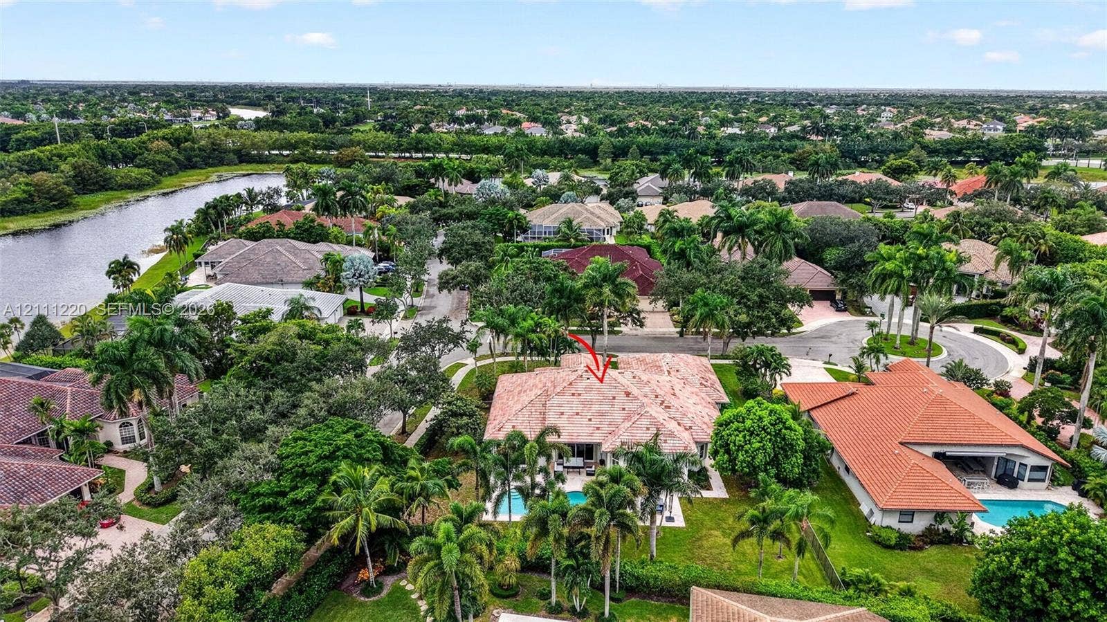 134 Dockside Terrace, Weston, FL 33327 Aerial perspective of a property featuring a tile roof, an in-ground swimming pool, and mature landscaping